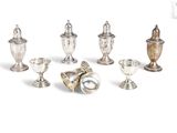seven silver vases and two silver cups on a white background