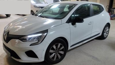 a white car parked in a garage with other cars in the background