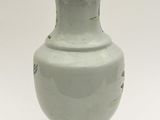 a white vase with a brown lid sitting on a table