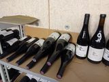 many bottles of wine sitting on a shelf next to each other