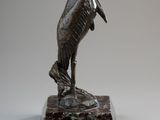 statue of a pelican on a rock on a white background
