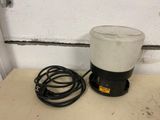 a white and black blender sitting on a counter next to a black cord