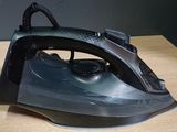 a black iron sitting on a wooden table