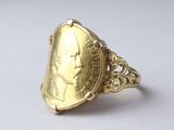 an image of a gold ring with a coin in the middle