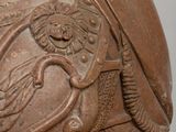 statue of a woman with a bird on her shoulder and a shield on her shoulder
