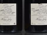 two bottles of wine that are sitting on a table