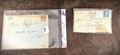 two envelopes with stamps are sitting on a brown surface