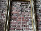 a picture of a picture frame hanging on a brick wall