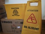 yellow caution sign sitting on top of a wooden table next to boxes