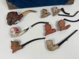 many different types of smoking pipes on the table