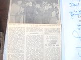 newspapers are sitting on a table with a piece of paper next to it