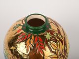 a vase with a design on it on a table