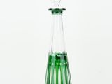 a glass bottle with a green liquid inside of it