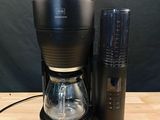 an image of a coffee maker and a coffee grinder on a wooden table