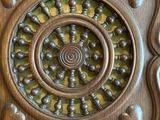 a wooden panel with a circular design on it