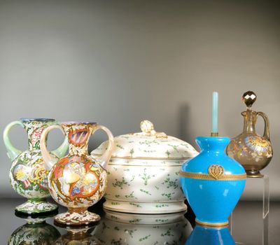 three vases and a teapot sitting on a table