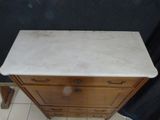 a marble top dresser with a marble top on it