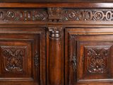 a large wooden cabinet with carvings on the doors