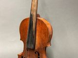 an old violin sitting on top of a table next to a wall