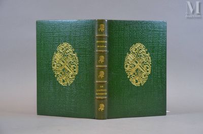 un vieux livre à la couverture verte posé sur une table