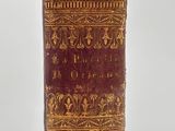 an old book sitting on top of a white surface