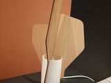wooden utensils in a white vase on top of a black dresser