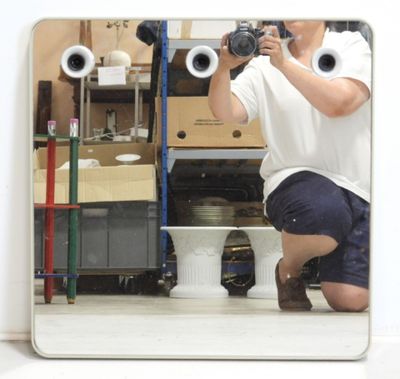 a man that is taking a picture of himself in the mirror