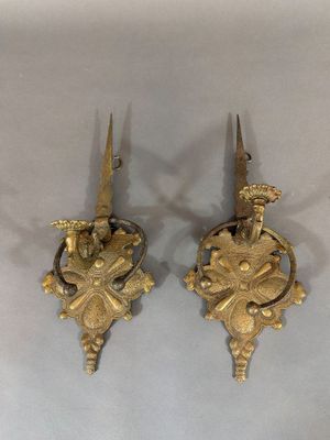 pair of antique brass wall sconces in the shape of a bird