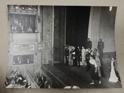 a black and white photo of a group of people on stage