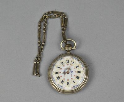 a gold pocket watch with roman numerals on it