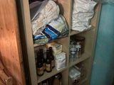 a pantry with a lot of food and drinks on the shelves
