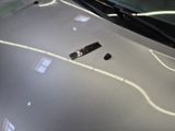 a close up of a car ' s hood with a remote control