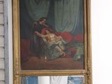 un homme en train de prendre une photo d'un tableau dans un miroir