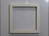 an empty picture frame hanging on a wall in a room