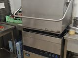 a large commercial fryer sitting in the middle of a kitchen