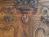 a large wooden cabinet with carvings on the top of it