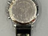 a watch that is sitting on a white surface