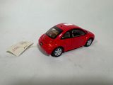 a small red car with a tag attached to it