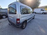 a silver van that is parked in a parking lot
