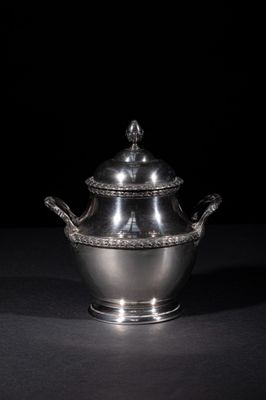 an antique silver plated sugar dish with a lid and handles