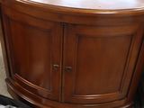 a corner table with a drawer on it in the middle of a room