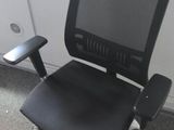 a black office chair with a computer monitor on the back of it
