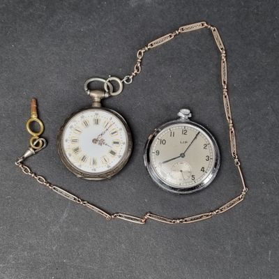 two different types of pocket watches on the table
