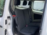 a white van that has a black seat in the back of it