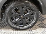 a close up of a tire on a car on a checkered floor