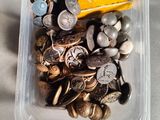 a plastic container filled with lots of different types of coins