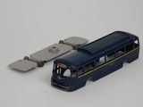 a toy bus that is sitting next to a piece of metal