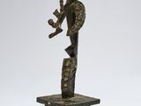 a bronze statue of a man holding a child on a rock