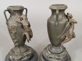two vases sitting on top of each other on a table