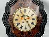 a clock that is sitting on the wall with roman numerals on it